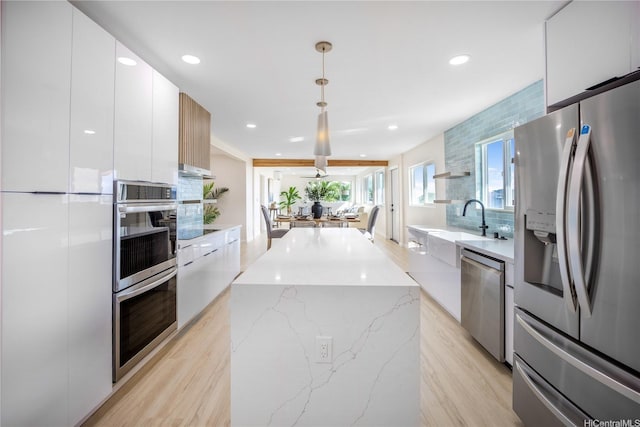 1849 Vancouver Pl, Honolulu, HI 96822 - kitchen with a sink, modern cabinets, stainless steel appliances, white cabinets, and a kitchen island