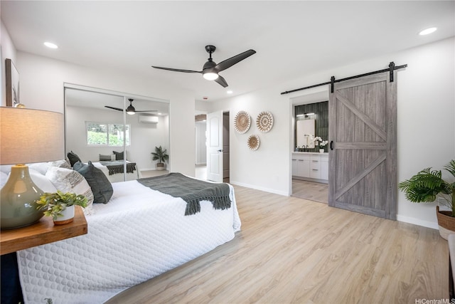 1849 Vancouver Pl, Honolulu, HI 96822 - bedroom with light wood finished floors, a ceiling fan, baseboards, and a barn door