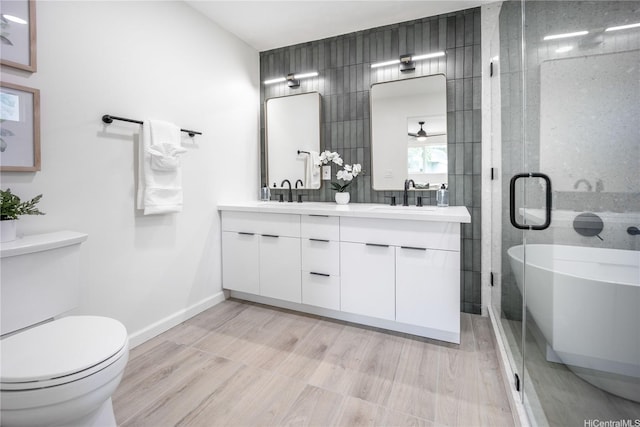 1849 Vancouver Pl, Honolulu, HI 96822 - full bathroom featuring a shower stall, a freestanding bath, double vanity, wood finished floors, and toilet