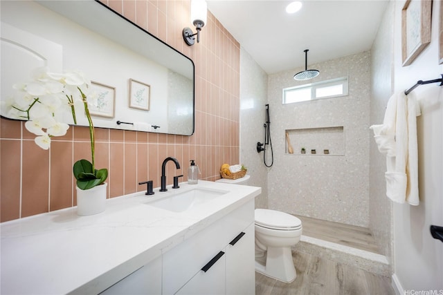 1849 Vancouver Pl, Honolulu, HI 96822 - bathroom with wood finished floors, vanity, tile walls, toilet, and tiled shower