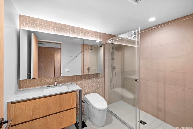 1000 Auahi St Unit 4106, Honolulu, HI 96814 - bathroom with toilet, a shower stall, tile walls, vanity, and recessed lighting