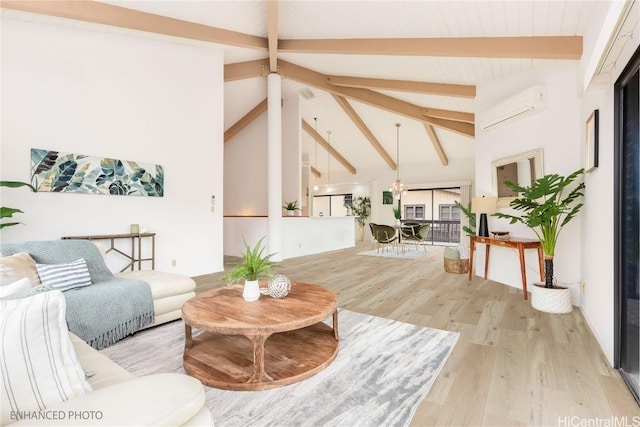 living room with beam ceiling, high vaulted ceiling, light hardwood / wood-style flooring, and an AC wall unit