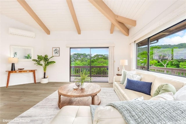 living room with wood-type flooring, lofted ceiling with beams, a wall unit AC, and a wealth of natural light