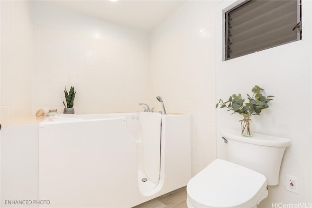 bathroom featuring wood-type flooring and toilet