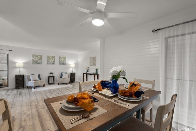 dining space with ceiling fan and hardwood / wood-style flooring