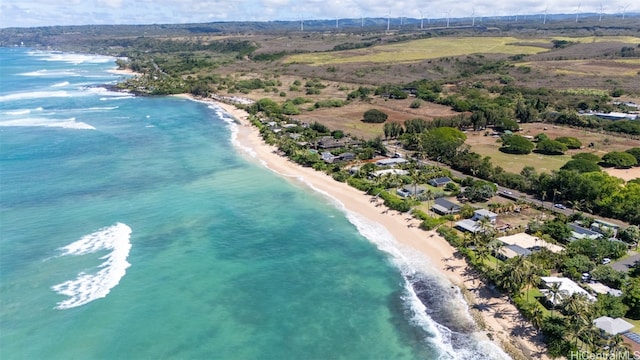 aerial view with a water view and a beach view