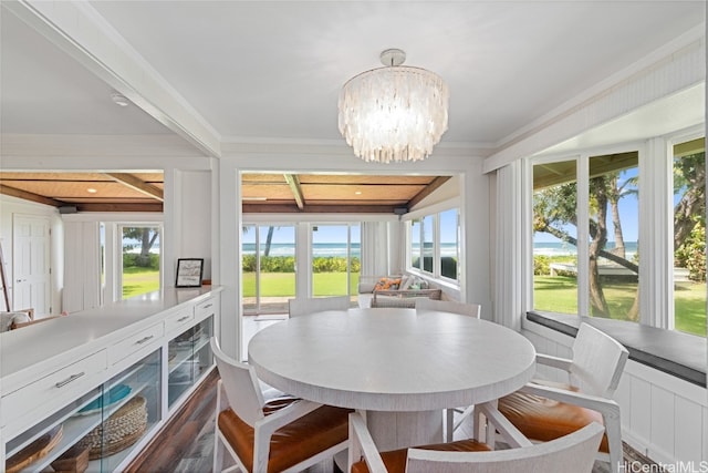 dining area with an inviting chandelier and ornamental molding