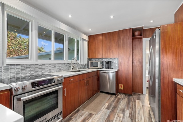 61-707 Papailoa Rd, Haleiwa, HI 96712 - kitchen with stainless steel appliances, a sink, brown cabinetry, tasteful backsplash, and recessed lighting
