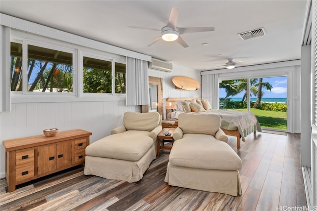 bedroom featuring dark hardwood / wood-style flooring, ceiling fan, access to exterior, an AC wall unit, and wooden walls