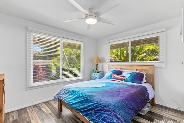 bedroom with hardwood / wood-style floors, crown molding, and ceiling fan