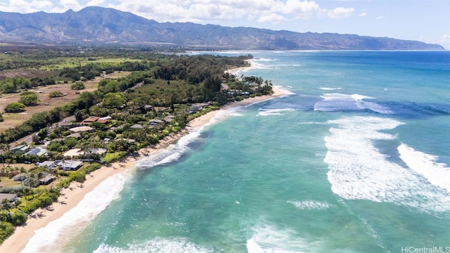 birds eye view of property featuring a water and mountain view and a beach view