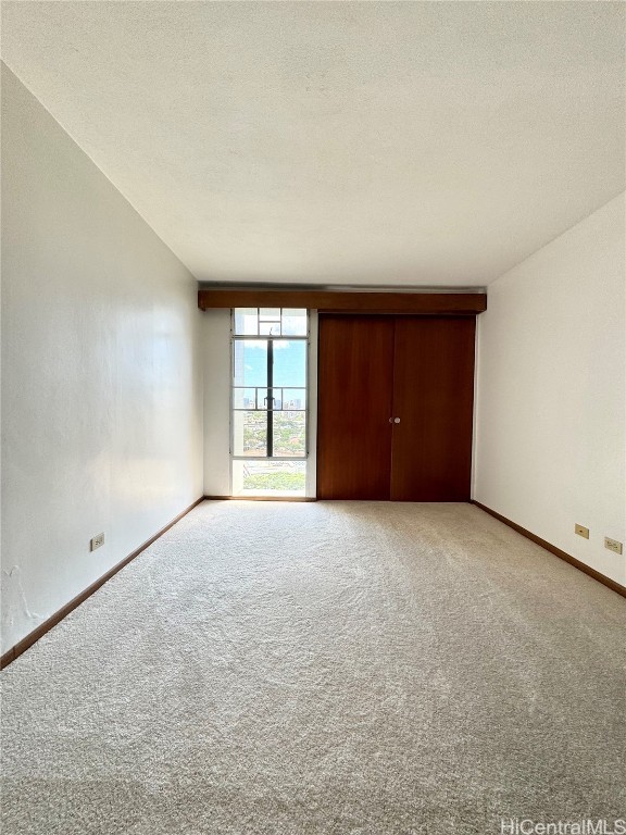 unfurnished bedroom featuring a textured ceiling and carpet floors