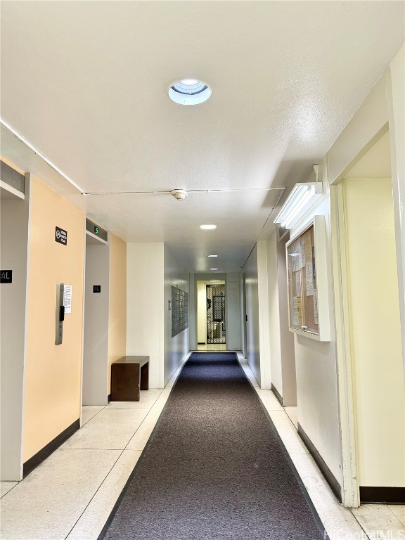 corridor featuring a textured ceiling