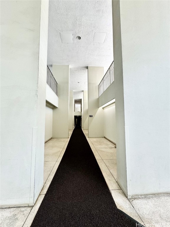 hall featuring a textured ceiling