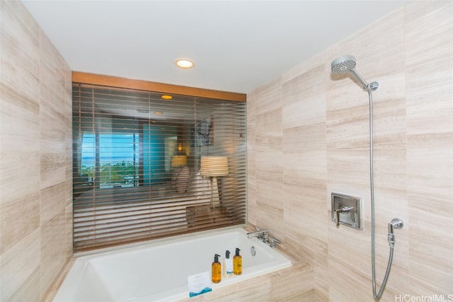 bathroom featuring tile walls and tiled shower / bath combo