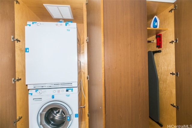 clothes washing area with stacked washer / drying machine