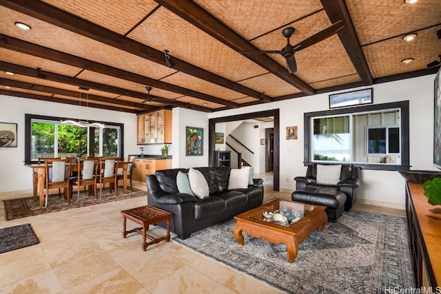 living room featuring beam ceiling and ceiling fan