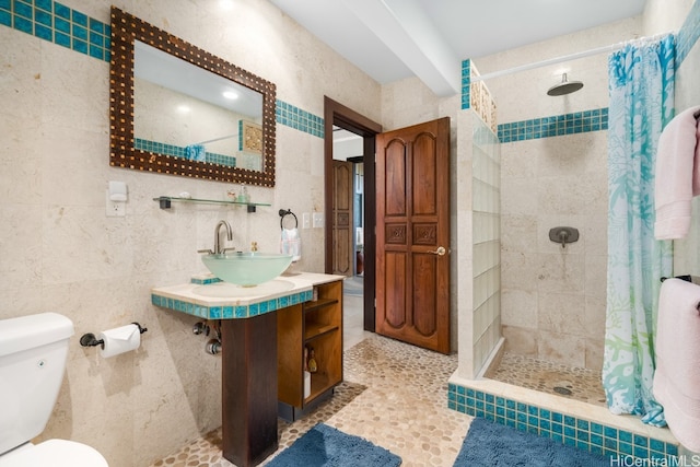 bathroom with tile walls, a shower with shower curtain, and toilet