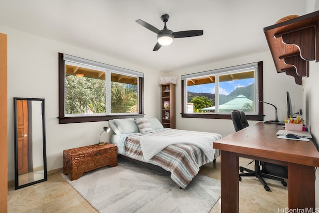 bedroom featuring multiple windows and ceiling fan