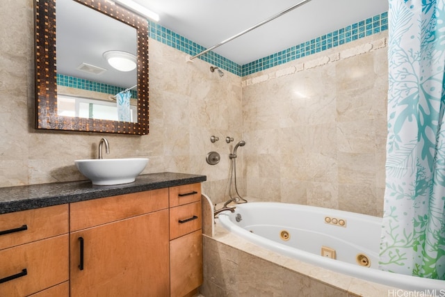 bathroom with tile walls, vanity, and shower / tub combo with curtain