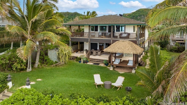 rear view of property with a yard