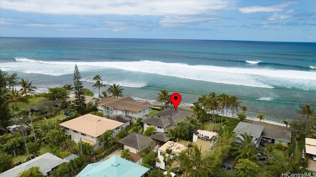 birds eye view of property with a water view and a beach view