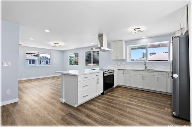 kitchen with appliances with stainless steel finishes, white cabinets, sink, and ventilation hood