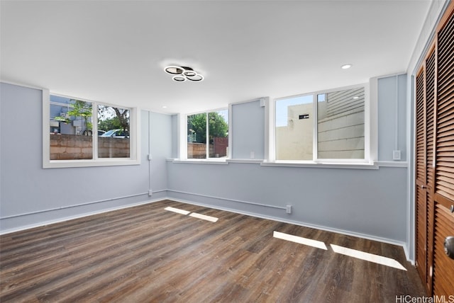 unfurnished bedroom with a closet and dark hardwood / wood-style flooring