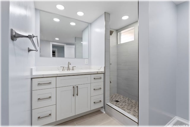 bathroom featuring vanity and tiled shower