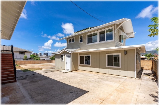 rear view of property featuring a patio area