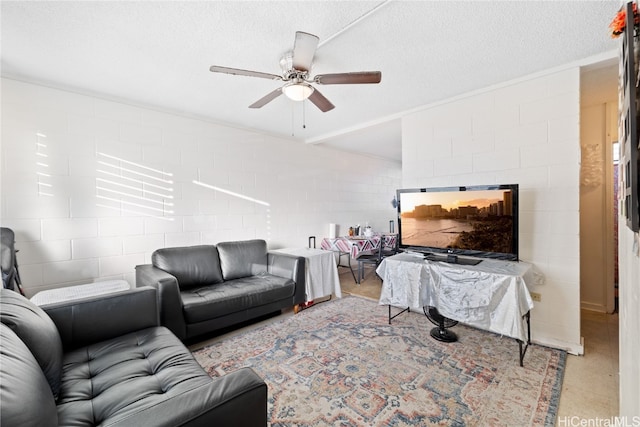 living room featuring ceiling fan and a textured ceiling