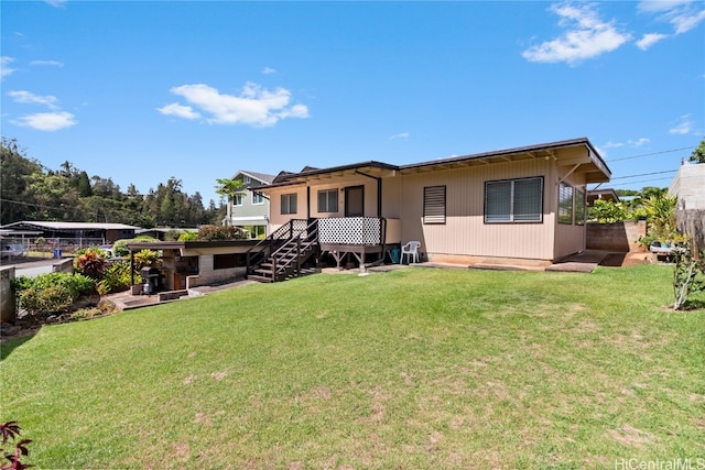 rear view of house featuring a lawn