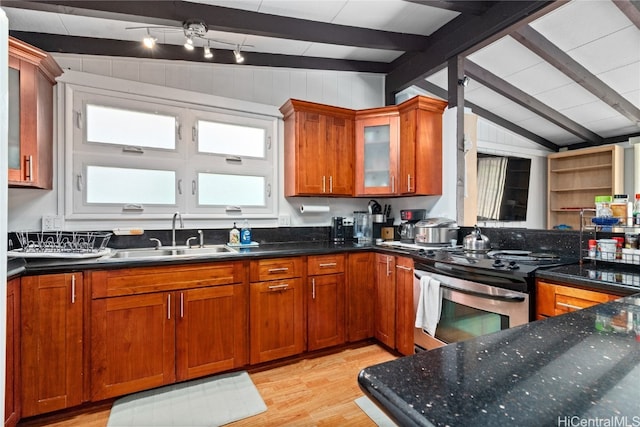 kitchen with sink, lofted ceiling with beams, stainless steel stove, and light hardwood / wood-style floors