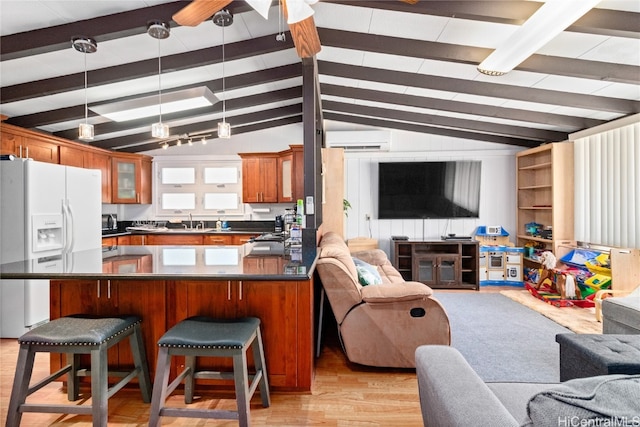 kitchen featuring kitchen peninsula, a wall mounted AC, white fridge with ice dispenser, light hardwood / wood-style flooring, and lofted ceiling with beams