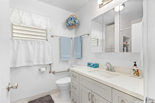 bathroom featuring toilet, vanity, and tile patterned flooring