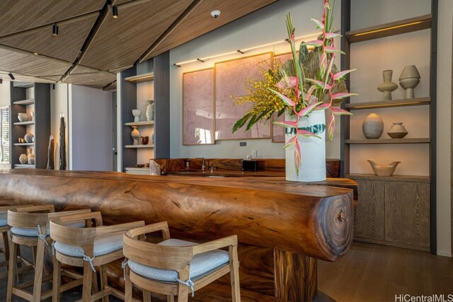 bar with wood-type flooring