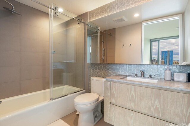 full bathroom featuring vanity, enclosed tub / shower combo, toilet, and tasteful backsplash