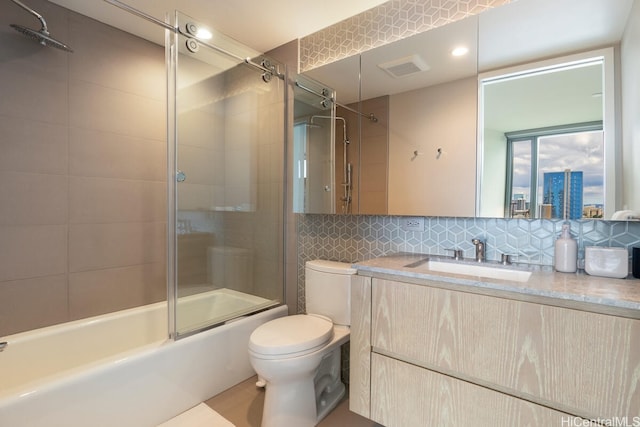 1000 Auahi St Unit 2503, Honolulu, HI 96814 - full bathroom with tasteful backsplash, tile patterned floors, combined bath / shower with glass door, vanity, and toilet