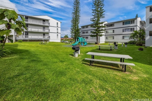 view of home's community with a lawn and a playground