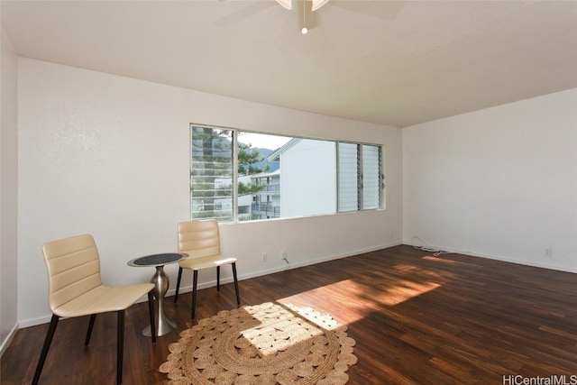 sitting room featuring dark hardwood / wood-style flooring and ceiling fan