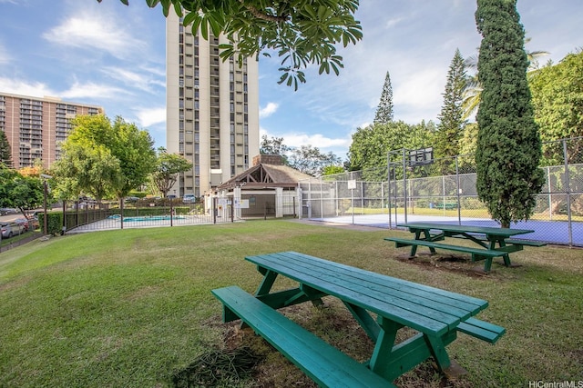 98-500 Koauka Loop Unit 18D, Aiea, HI 96701 - surrounding community with fence, a lawn, and a pool