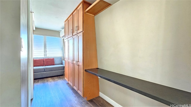 corridor featuring a wall mounted AC and dark hardwood / wood-style flooring