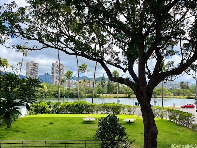 view of home's community featuring a water view and a yard