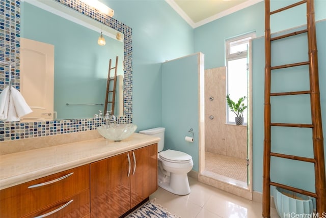 bathroom featuring a shower with door, toilet, tile patterned floors, vanity, and crown molding