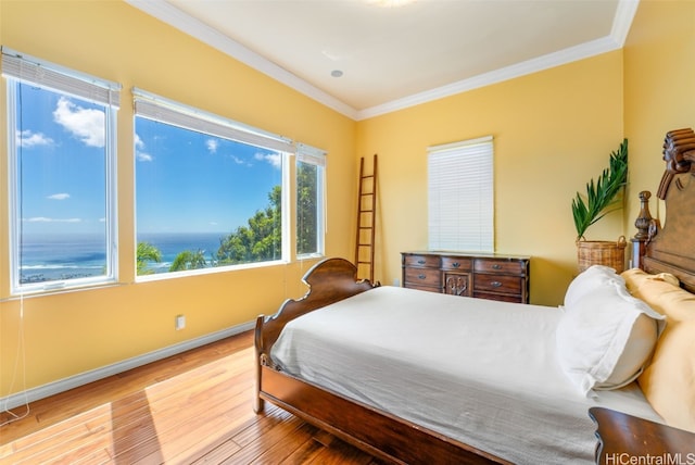 bedroom with light hardwood / wood-style floors and crown molding