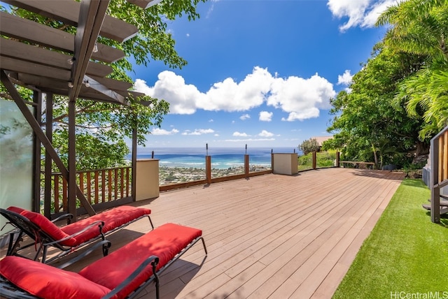 wooden deck featuring a water view and a view of the beach