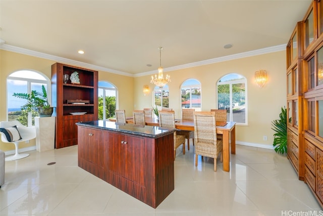 kitchen featuring crown molding, a center island, hanging light fixtures, and light tile patterned floors