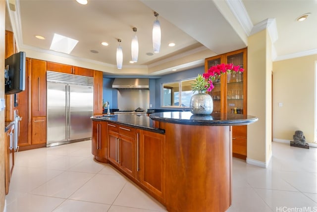 kitchen featuring stainless steel built in fridge, ornamental molding, light tile patterned flooring, pendant lighting, and a center island