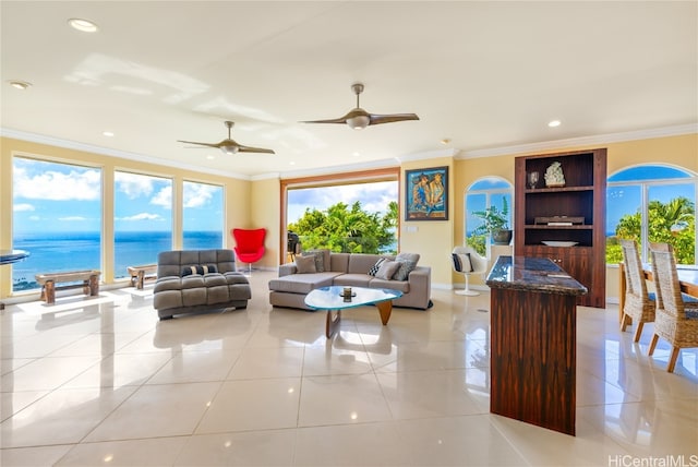 tiled living room with ornamental molding, a water view, and ceiling fan