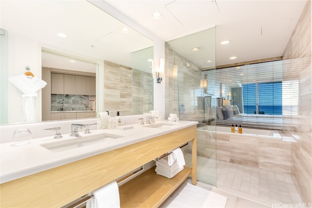 bathroom with tile walls, vanity, a shower with shower door, and tile patterned floors